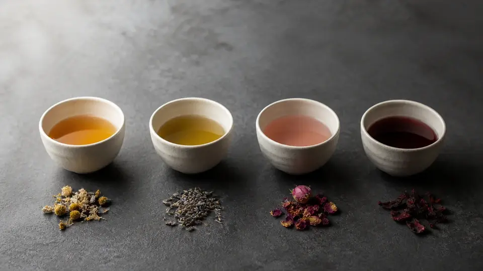 Four unbranded cups illustrating cycle phase tea rituals
